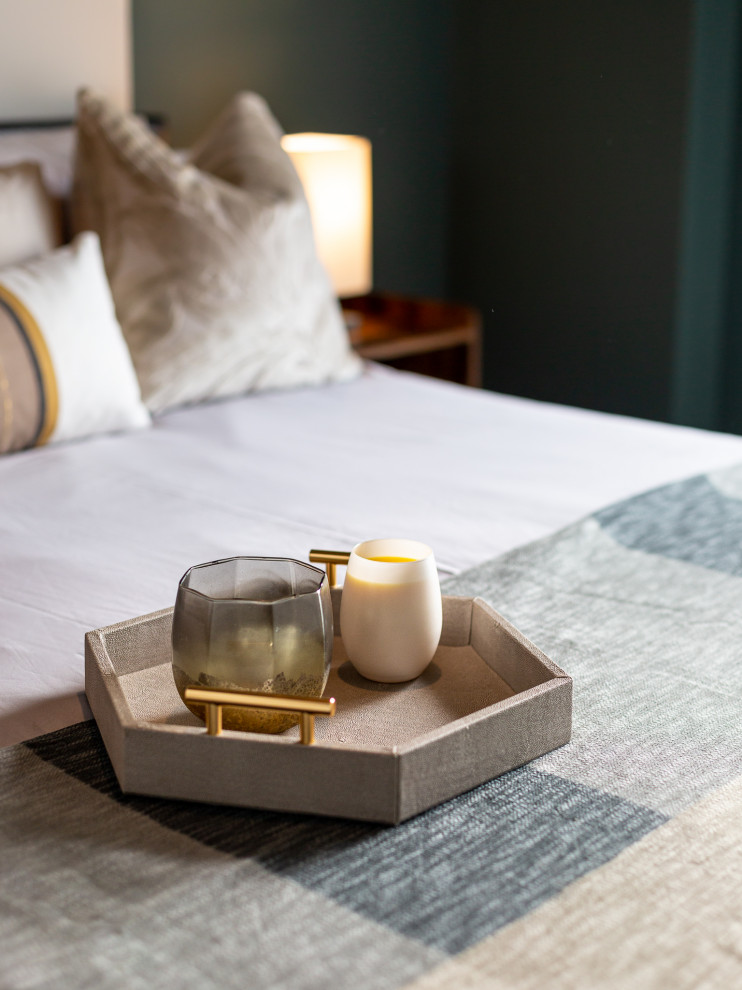 Design ideas for an industrial master and grey and teal bedroom in London with carpet, grey floors and a feature wall.