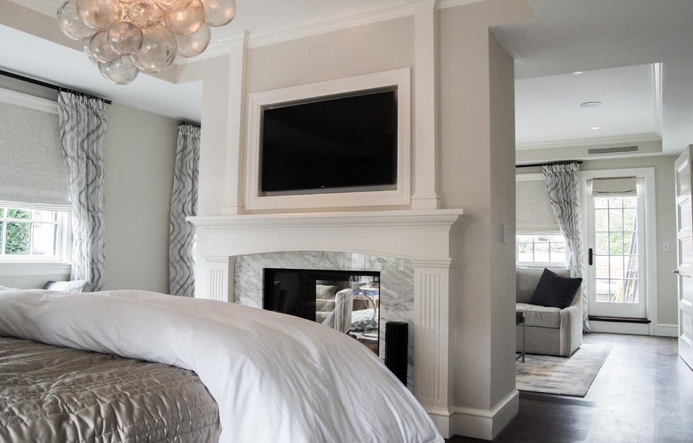 Photo of a mid-sized transitional master bedroom in Boston with white walls, dark hardwood floors, a two-sided fireplace and a stone fireplace surround.