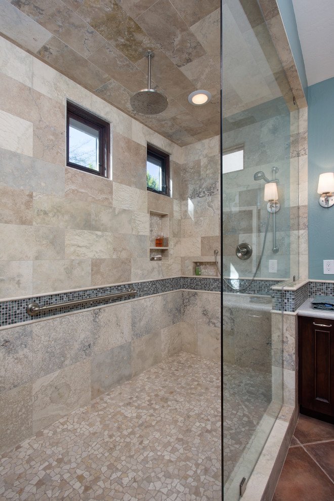 Walk-in shower - large transitional master gray tile and stone tile ceramic tile walk-in shower idea in Phoenix with an undermount sink, raised-panel cabinets, dark wood cabinets, granite countertops and blue walls