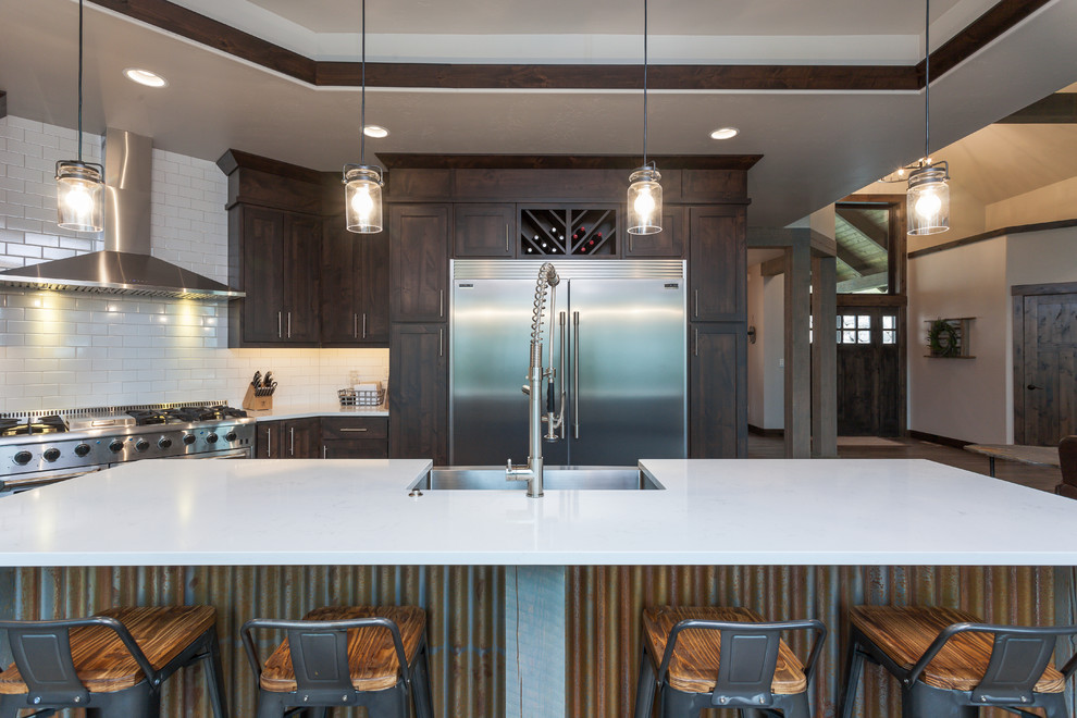 Kitchen - rustic kitchen idea with a farmhouse sink, white backsplash, ceramic backsplash, stainless steel appliances and an island