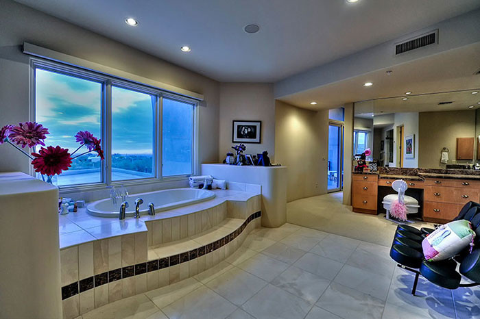 Drop-in bathtub - huge transitional master white tile and porcelain tile porcelain tile drop-in bathtub idea in Phoenix with flat-panel cabinets, medium tone wood cabinets, a one-piece toilet, beige walls, a drop-in sink and granite countertops