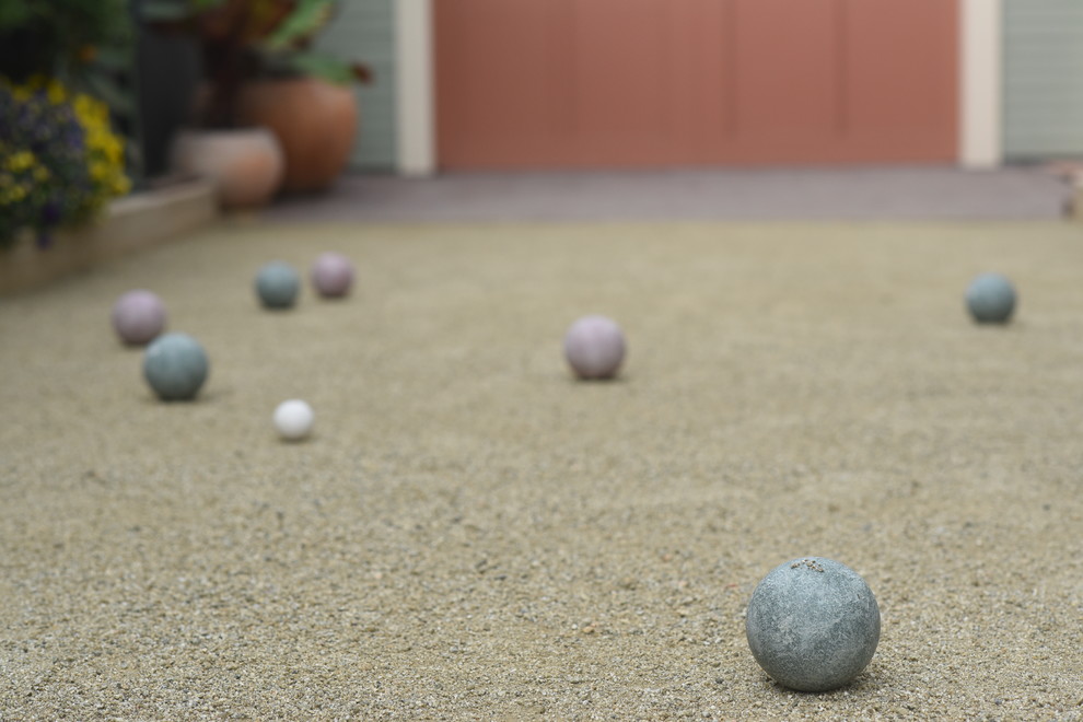 Inspiration for a small beach style side yard driveway in Santa Barbara with with outdoor playset and gravel.
