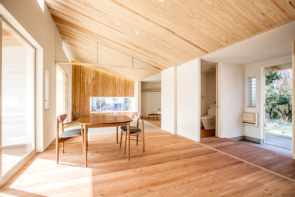 This is an example of a large scandinavian open plan dining in Osaka with light hardwood floors.