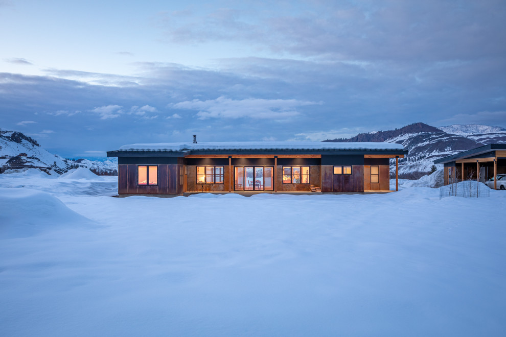 Inspiration for a modern one-story metal house exterior remodel with a shed roof