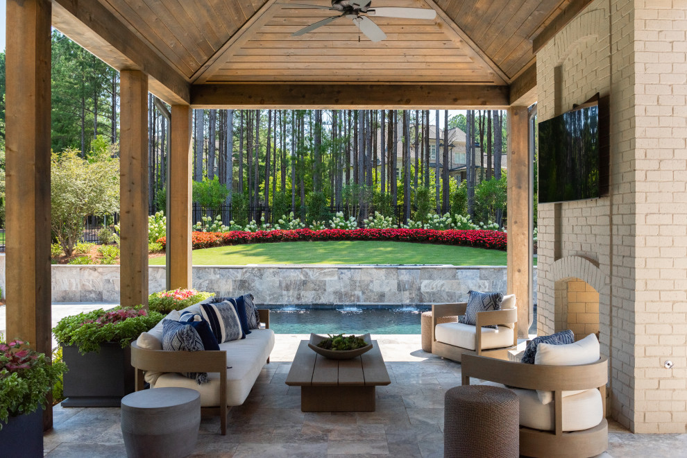 Large transitional backyard stone patio photo in Atlanta with a fireplace