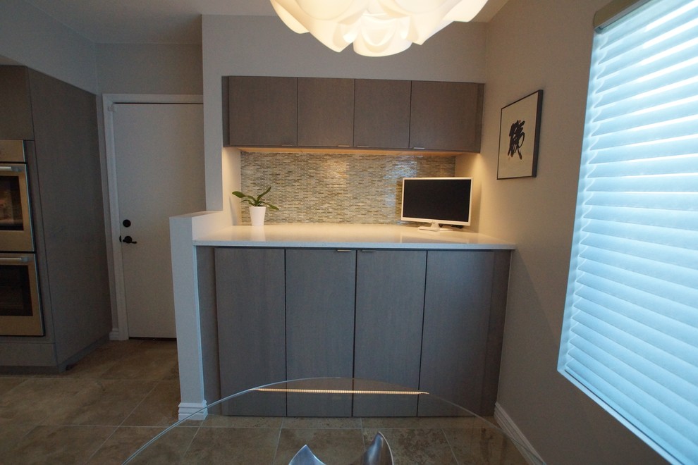 This is an example of a mid-sized contemporary single-wall laundry cupboard in Phoenix with flat-panel cabinets, grey cabinets, quartz benchtops, grey walls, a side-by-side washer and dryer and beige floor.