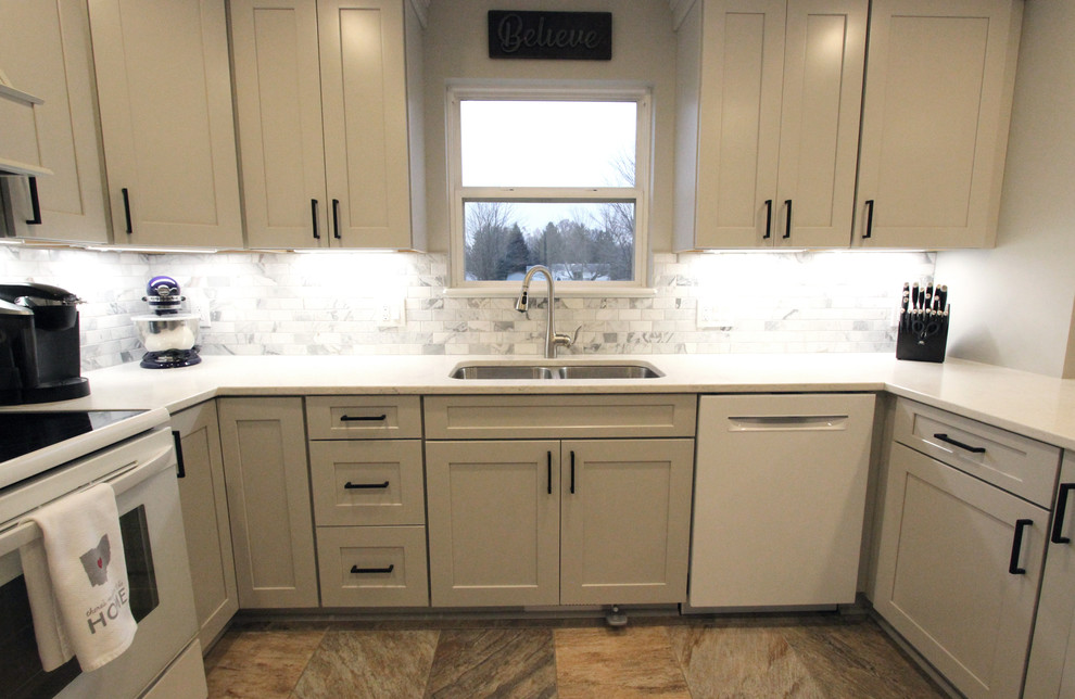 Photo of a mid-sized transitional u-shaped eat-in kitchen in Cleveland with an undermount sink, flat-panel cabinets, grey cabinets, quartz benchtops, grey splashback, marble splashback, white appliances, a peninsula, white benchtop and multi-coloured floor.