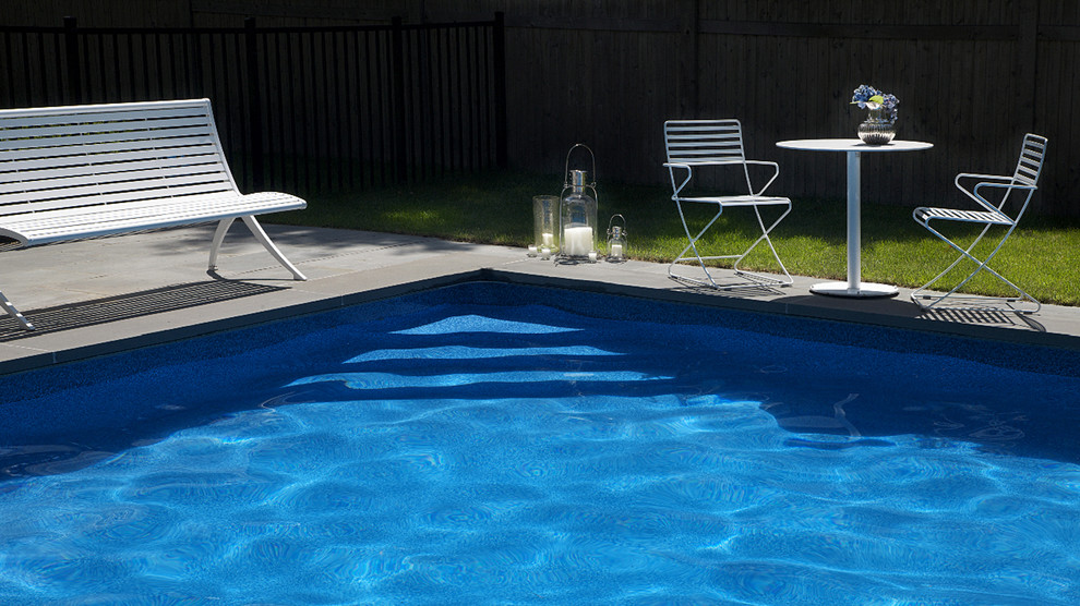 Pool - large mediterranean backyard stone and rectangular pool idea in New York