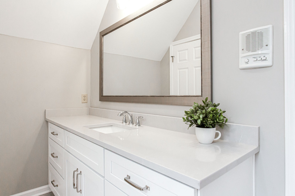 Photo of a mid-sized transitional master bathroom in Atlanta with shaker cabinets, white cabinets, a claw-foot tub, an open shower, a one-piece toilet, gray tile, porcelain tile, grey walls, porcelain floors, an undermount sink, engineered quartz benchtops, grey floor, an open shower, grey benchtops, a shower seat, a double vanity, a built-in vanity, vaulted and decorative wall panelling.