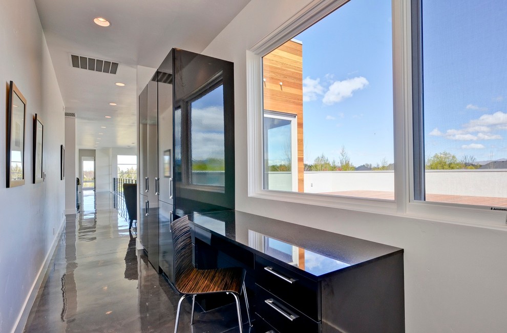 Photo of a contemporary home office in Boise with concrete floors.