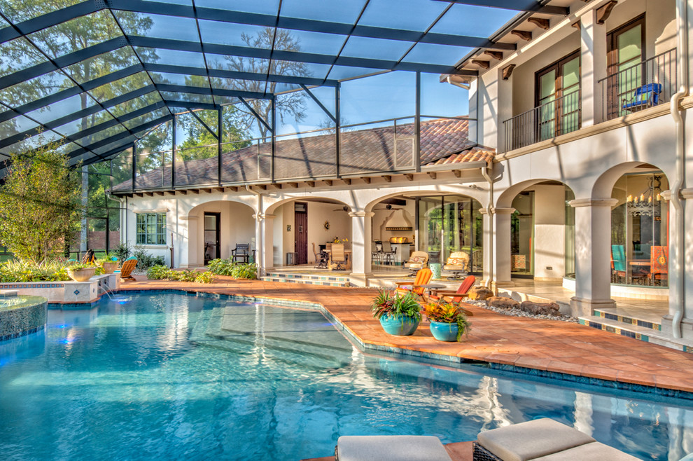 Inspiration for a large mediterranean indoor custom-shaped pool in Houston with natural stone pavers.