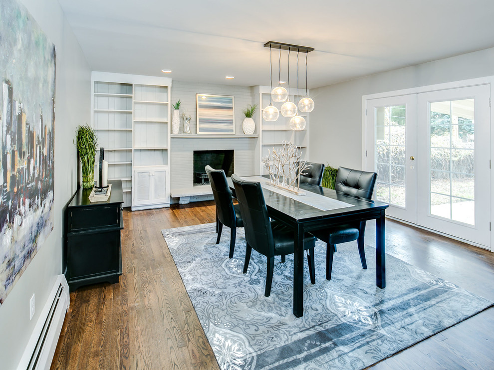 Enclosed dining room - mid-sized transitional medium tone wood floor enclosed dining room idea with gray walls