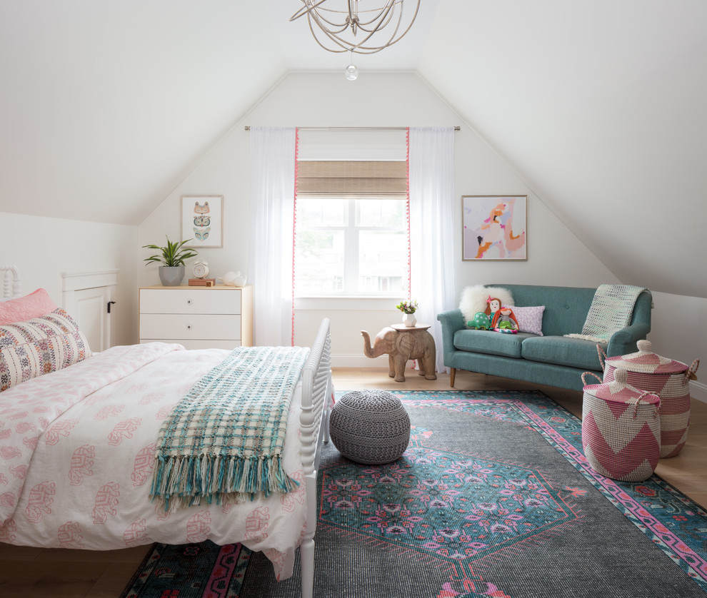 This is an example of a large eclectic kids' room for girls in Boston with white walls, light hardwood floors and beige floor.