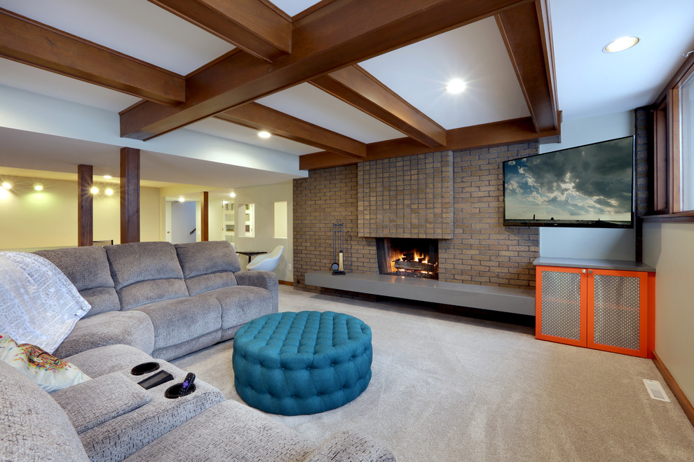 Photo of a mid-sized midcentury look-out basement in Grand Rapids with white walls, light hardwood floors, a standard fireplace, a brick fireplace surround and beige floor.