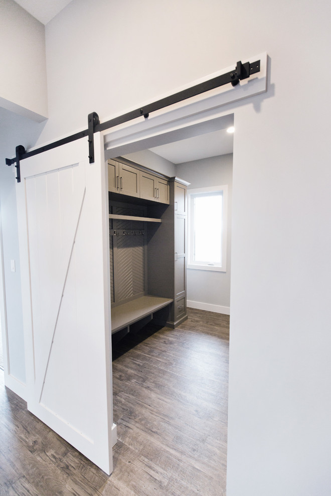 Inspiration for a transitional laminate floor entryway remodel in Calgary