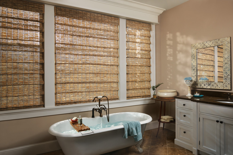 Large mountain style master beige tile and travertine tile ceramic tile and beige floor freestanding bathtub photo in Chicago with recessed-panel cabinets, white cabinets, beige walls, an undermount sink and granite countertops