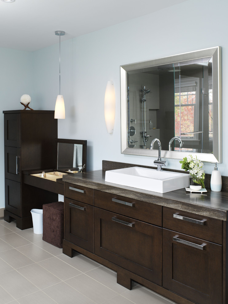 Transitional bathroom in Toronto with a console sink, shaker cabinets, dark wood cabinets, marble benchtops, a drop-in tub, a two-piece toilet, gray tile, porcelain tile, grey walls and porcelain floors.