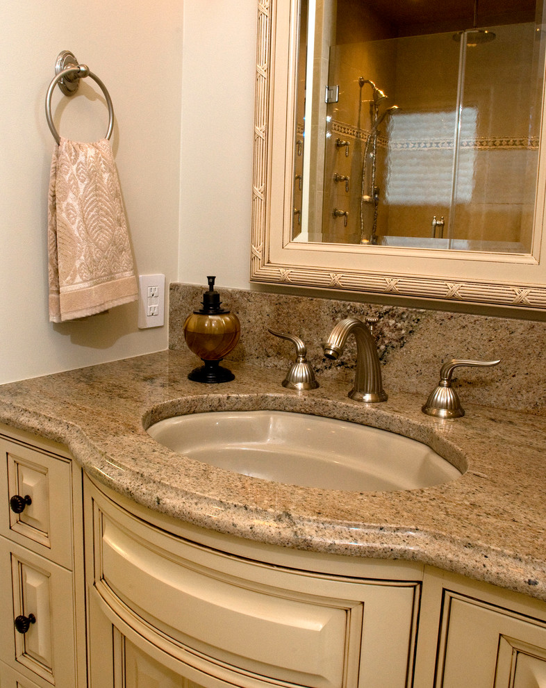 Inspiration for a large transitional master bathroom in Wilmington with raised-panel cabinets, beige cabinets, a drop-in tub, an open shower, a one-piece toilet, porcelain floors, an undermount sink, granite benchtops, beige floor, a hinged shower door, grey benchtops, a double vanity and a built-in vanity.