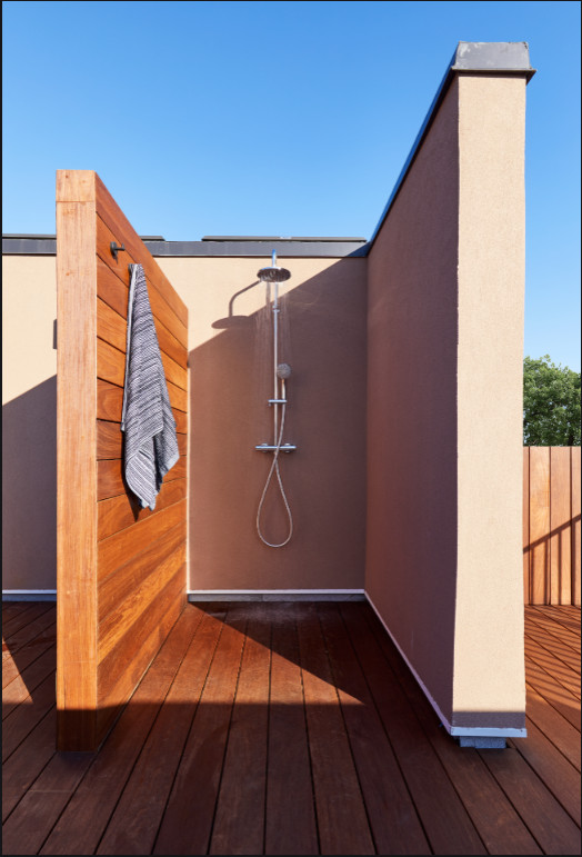 Mid-sized modern backyard patio in New York with an outdoor shower, decking and no cover.