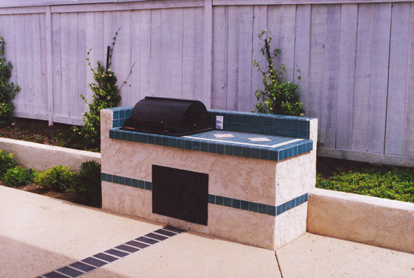 Inspiration for a mid-sized traditional backyard custom-shaped lap pool in San Diego with a hot tub and concrete slab.