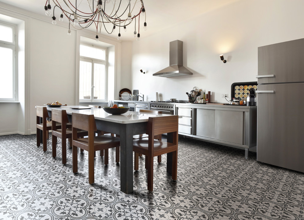 Photo of an industrial kitchen in Wiltshire with terrazzo floors and grey floor.