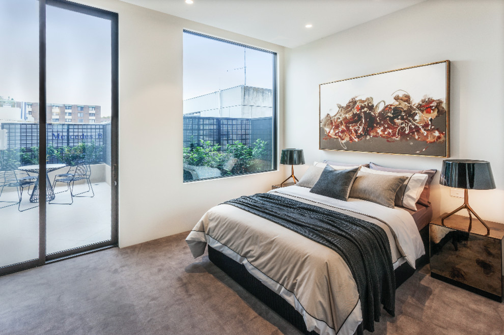 Small modern guest bedroom in Melbourne with white walls, carpet and no fireplace.