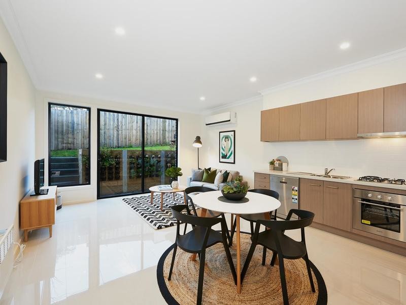 Small modern open plan dining in Melbourne with beige walls, porcelain floors, no fireplace and beige floor.