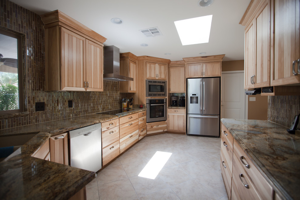 Enclosed kitchen - large transitional galley ceramic tile enclosed kitchen idea in Phoenix with an undermount sink, recessed-panel cabinets, light wood cabinets, granite countertops, brown backsplash, glass tile backsplash and stainless steel appliances