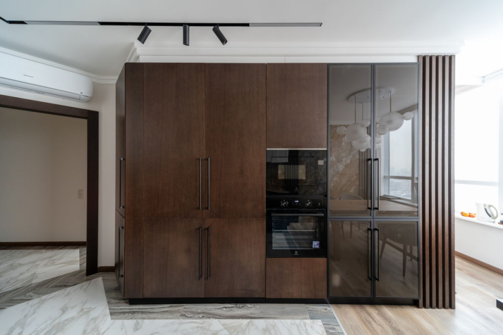 Large contemporary l-shaped kitchen/diner in Moscow with a double-bowl sink, flat-panel cabinets, dark wood cabinets, engineered stone countertops, brown splashback, engineered quartz splashback, black appliances, no island and beige worktops.