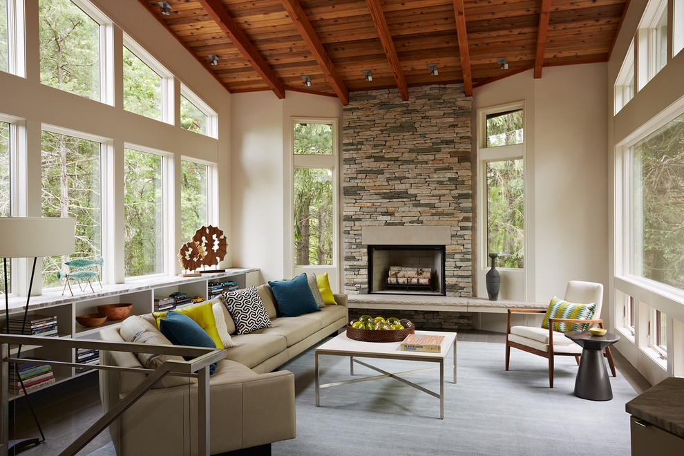 This is an example of a small contemporary enclosed living room in Minneapolis with white walls, slate floors, a standard fireplace, a stone fireplace surround and no tv.