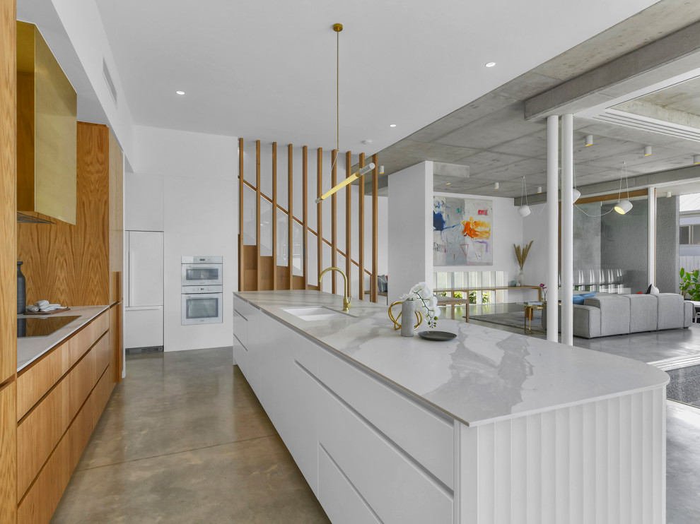 Design ideas for a scandinavian kitchen in Brisbane with light wood cabinets, marble benchtops, marble splashback, concrete floors, a peninsula and grey floor.