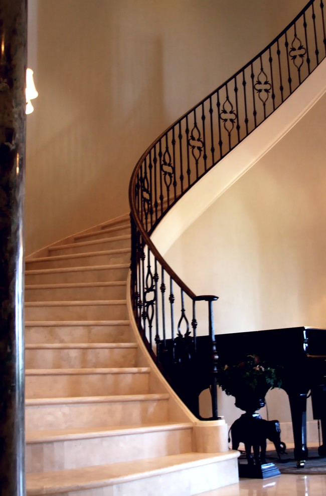Photo of a large traditional spiral staircase in Dallas.