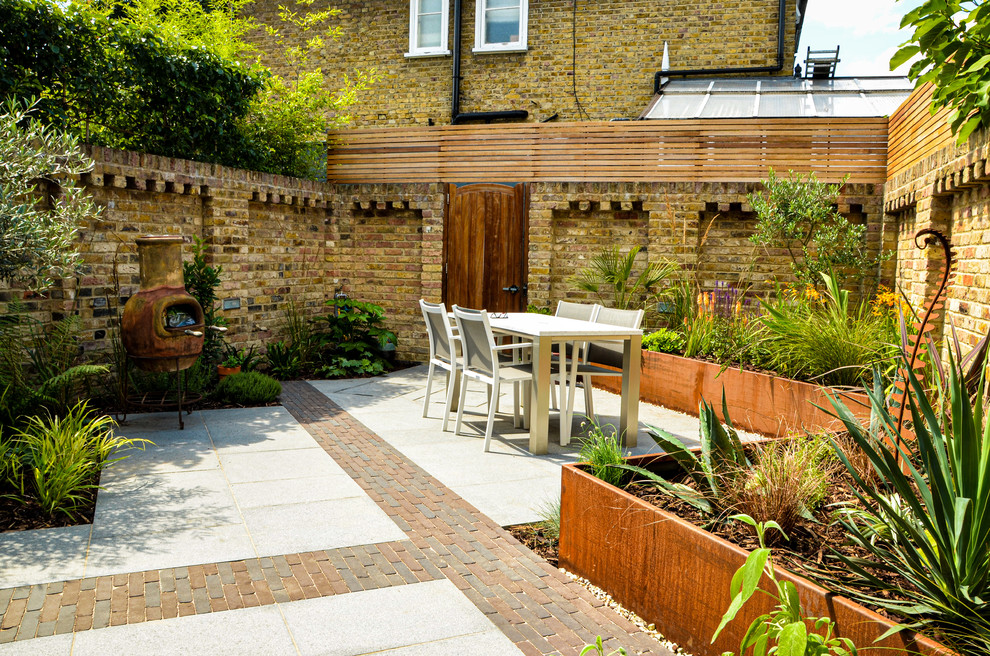 Photo of a small contemporary backyard partial sun garden for summer in London.