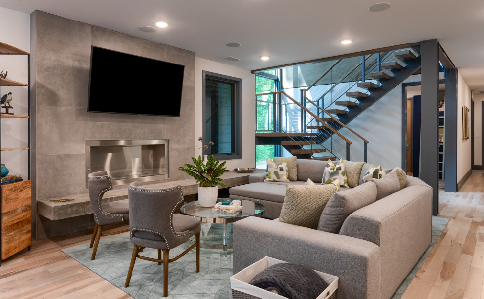 Contemporary open concept living room in Other with white walls, light hardwood floors, a ribbon fireplace, a tile fireplace surround, a wall-mounted tv and beige floor.