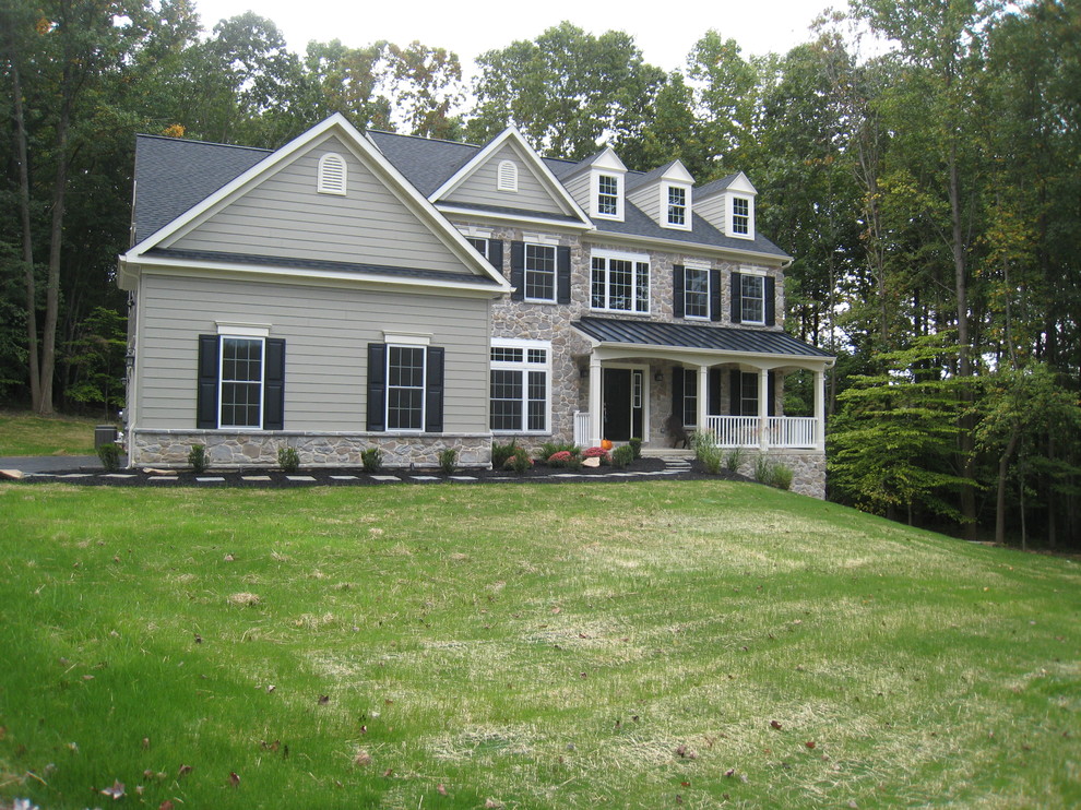 Photo of a large traditional two-storey green exterior in Philadelphia with concrete fiberboard siding.