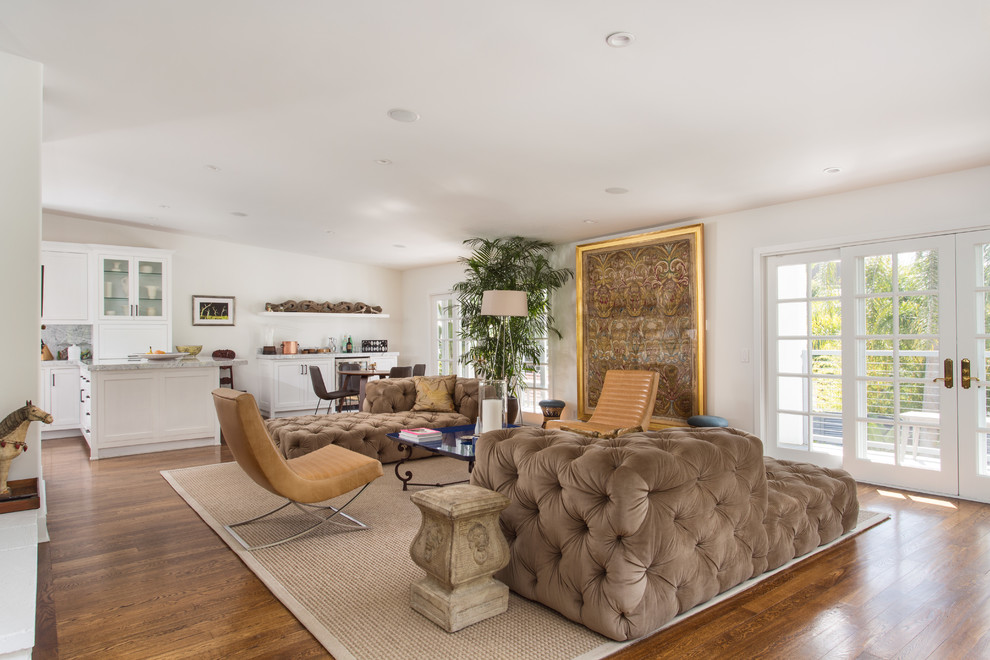 Inspiration for a large contemporary open concept medium tone wood floor and brown floor living room remodel in Los Angeles with white walls, a standard fireplace, a stone fireplace and a wall-mounted tv