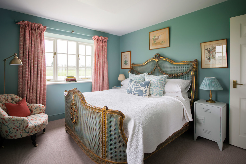 Photo of a rural grey and teal bedroom in Gloucestershire with green walls, carpet and beige floors.