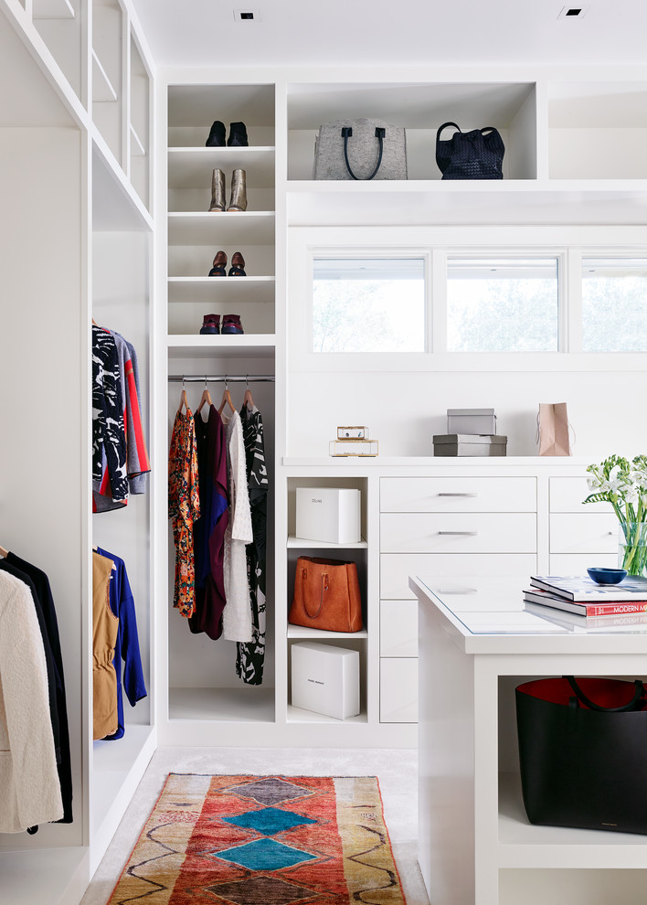 Inspiration for a large contemporary women's walk-in wardrobe in Austin with flat-panel cabinets, white cabinets, carpet and white floor.