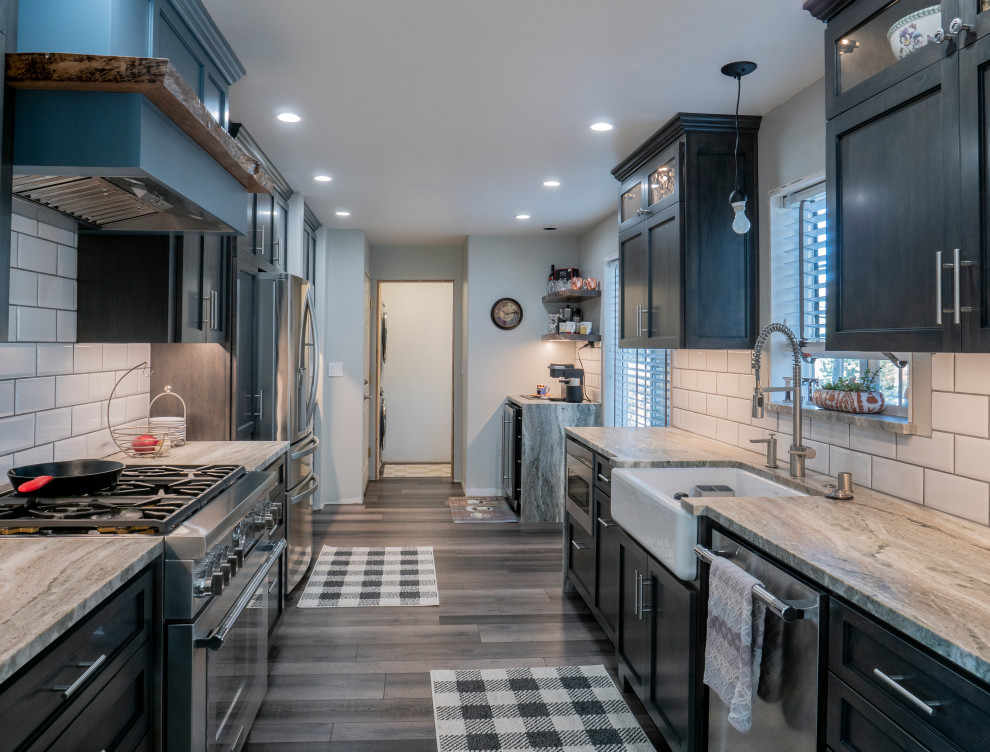 Large modern galley eat-in kitchen in Sacramento with black cabinets, marble benchtops, white splashback, subway tile splashback, stainless steel appliances and green benchtop.