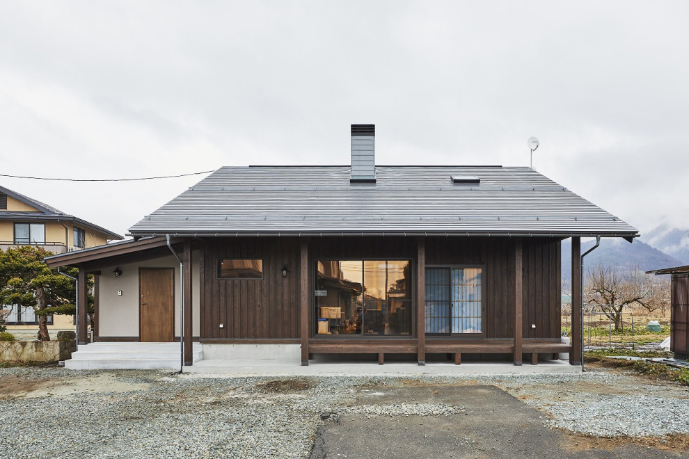Inspiration för ett mellanstort brunt hus, med två våningar, halvvalmat sadeltak och tak i metall