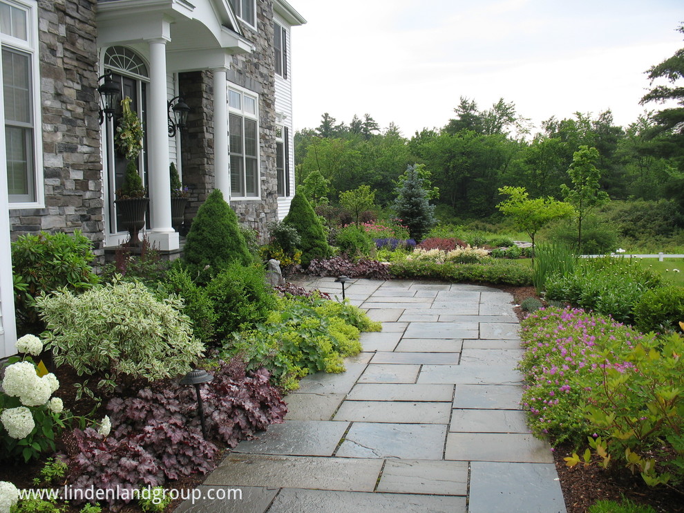 Photo of an expansive contemporary front yard full sun garden in Burlington with a garden path and natural stone pavers.