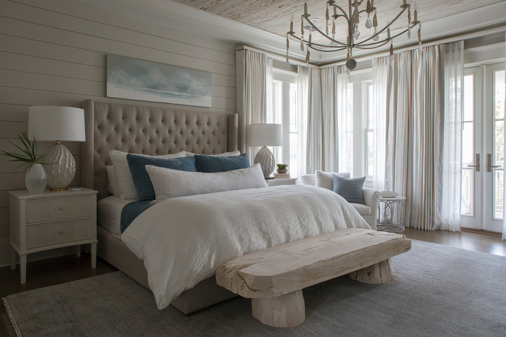 Photo of a beach style bedroom in Miami with beige walls, dark hardwood floors and brown floor.