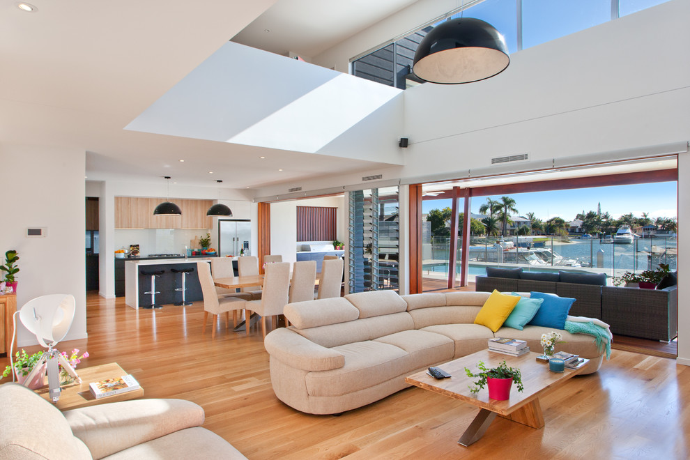 This is an example of a contemporary living room in Sunshine Coast with light hardwood floors.