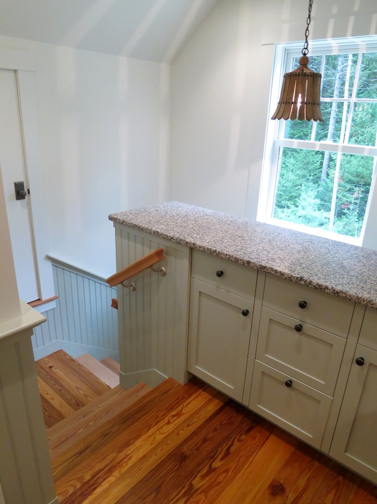 Small transitional l-shaped eat-in kitchen in Other with shaker cabinets, green cabinets, black splashback, white appliances, light hardwood floors, a single-bowl sink and granite benchtops.