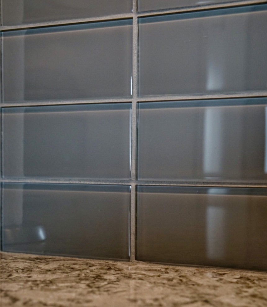 Transitional kitchen photo in Boston with quartz countertops, gray backsplash and glass tile backsplash