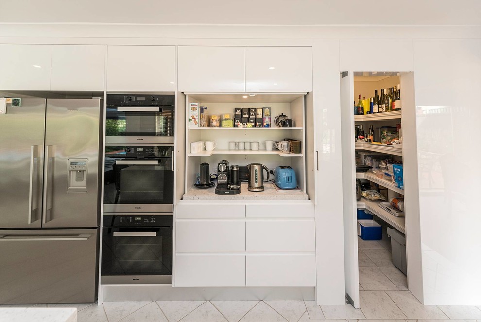 Design ideas for a large contemporary u-shaped open plan kitchen in Sydney with a drop-in sink, flat-panel cabinets, white cabinets, quartz benchtops, marble splashback, stainless steel appliances, ceramic floors, with island, grey splashback and grey benchtop.