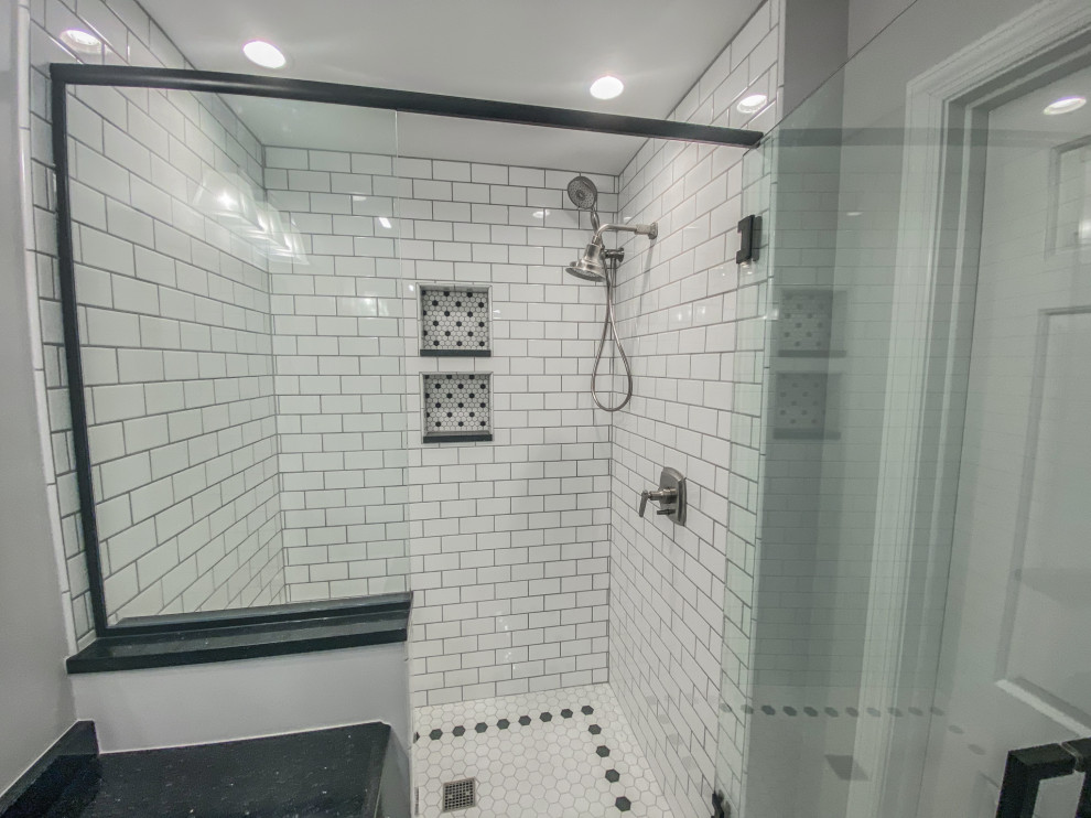 Bathroom - large 1960s white tile and ceramic tile porcelain tile and white floor bathroom idea in Other with raised-panel cabinets, black cabinets, gray walls, a hinged shower door, black countertops and a built-in vanity