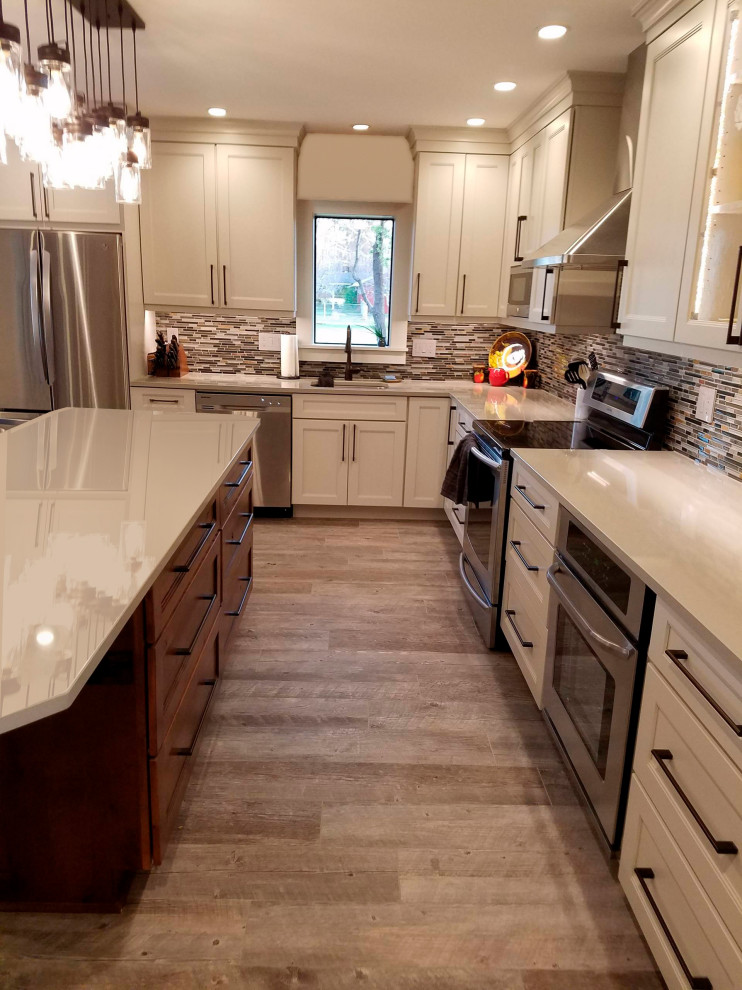 Design ideas for a large transitional l-shaped eat-in kitchen in Seattle with shaker cabinets, medium wood cabinets, quartz benchtops, stainless steel appliances, porcelain floors and with island.