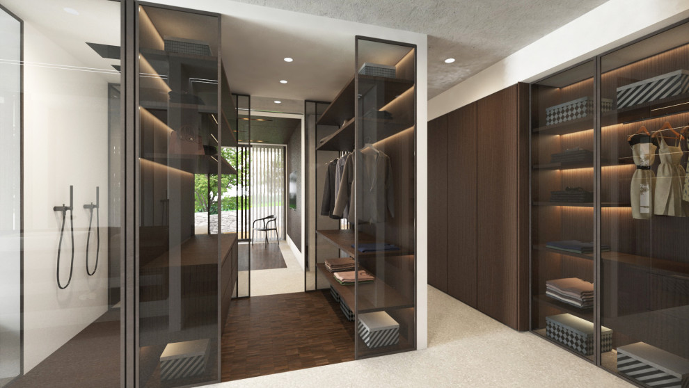 Large contemporary gender-neutral walk-in wardrobe in Other with glass-front cabinets, dark wood cabinets, porcelain floors, grey floor and recessed.