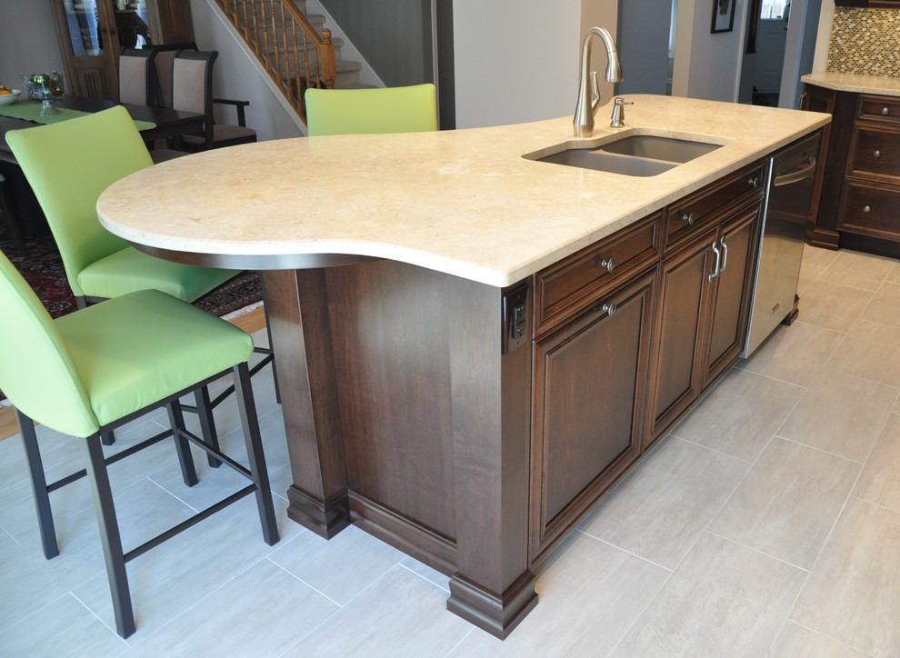 Mid-sized transitional l-shaped ceramic tile eat-in kitchen photo in Ottawa with an undermount sink, recessed-panel cabinets, dark wood cabinets, stainless steel appliances and an island